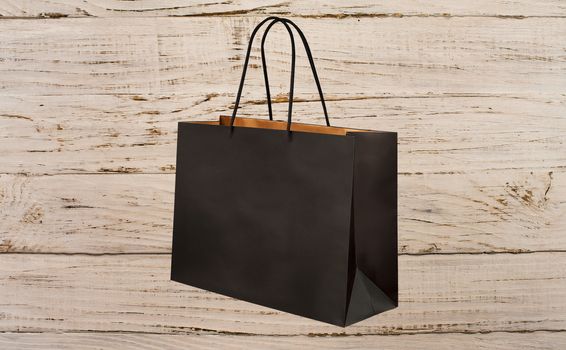 paper bag for shopping on a wooden background