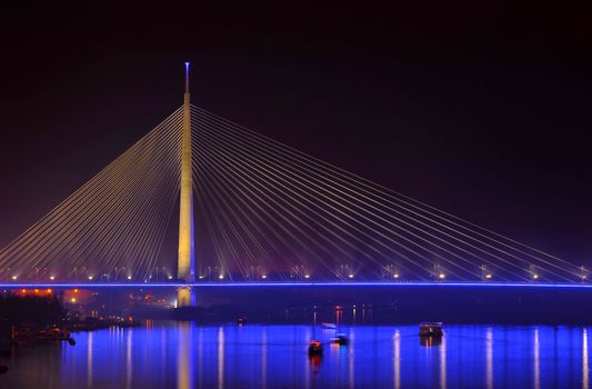 Ada bridge in Belgrade at night making reflection