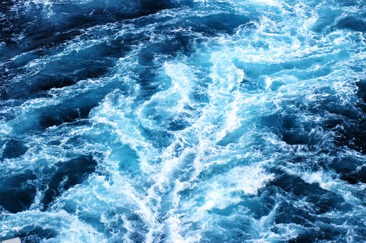 Blue white and black background of ship trail at sea