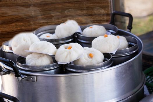 Chinese dumplings(steamed stuff bun) being steamed in steam box.