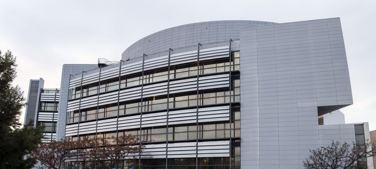 View of a modern urban office building with a lot of glass and geometrical lines.