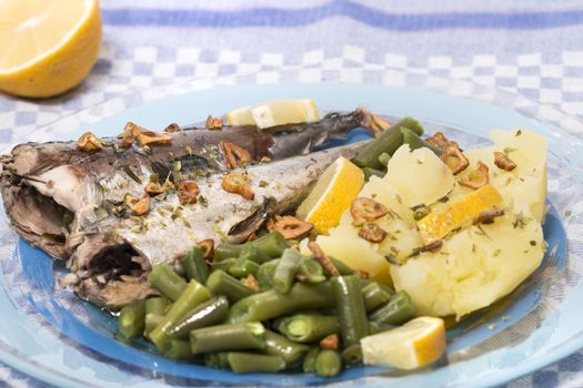 Homemade portuguese mackerel fish meal with potatoes and veggies.
