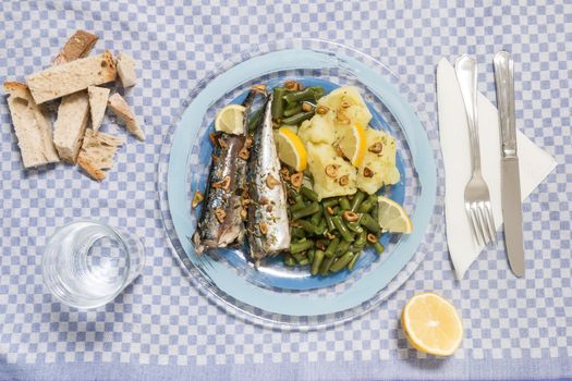 Homemade portuguese mackerel fish meal with potatoes and veggies.