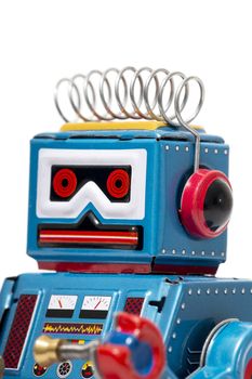 Vintage tin robot toy isolated on a white background.