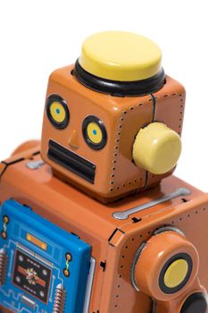 Vintage tin robot toy isolated on a white background.