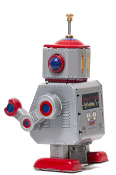 Vintage tin robot toy isolated on a white background.