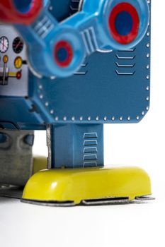 Vintage tin robot toy isolated on a white background.