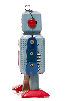 Vintage tin robot toy isolated on a white background.