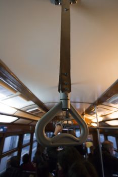 Commuter handle on a historical yellow tram on Lisbon city, Portugal.