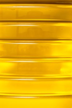 Close up macro of a plastic bottle filled with olive oil.