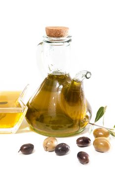 Green and black olives with olive oil bottle isolated on a white background.