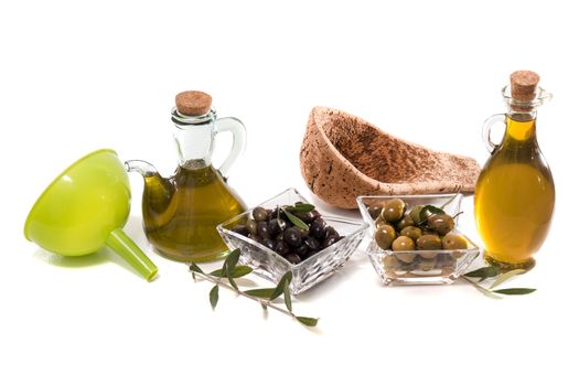 Green and black olives with olive oil bottles isolated on a white background.