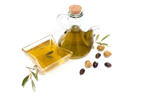 Green and black olives with olive oil bottle isolated on a white background.