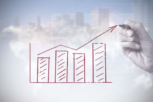 Hand drawing an upwards arrow business chart with skyscrapers in the background