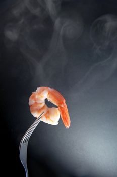 Hot shrimp on a fork with background space 