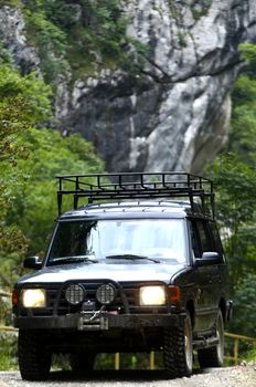 Off road vehicle passing gorge on the mountain