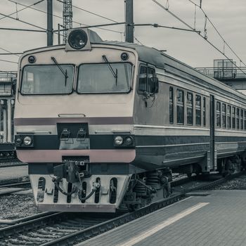 Old passenger diesel train moving at the terminal