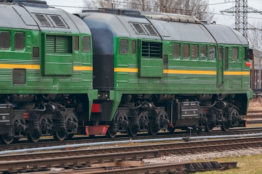 Green diesel cargo locomotive. Freight train in action