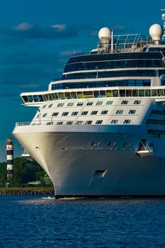 White giant brand new passenger ship moving in clear summer day