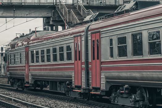 Red diesel passenger train driving at the old terminal