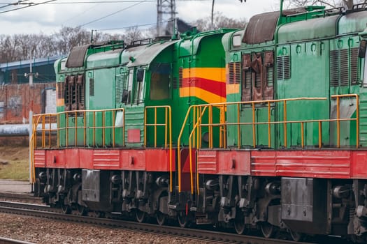 Green diesel cargo locomotive. Freight train in action