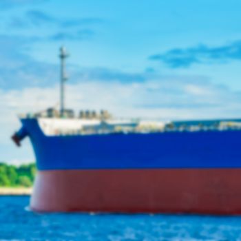 Blue cargo ship - soft lens bokeh image. Defocused background