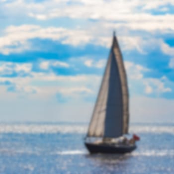 Blue sailboat - soft lens bokeh image. Defocused background