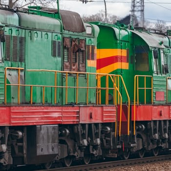 Green diesel cargo locomotive. Freight train in action