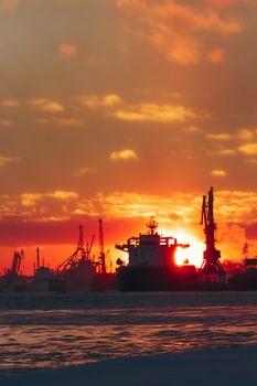 Colorful winter sunrise against the cargo port