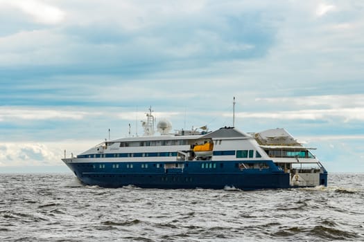 Small blue passenger ship sailing in Baltic sea. Spa services