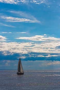 Blue sailboat in travel by Europe. Sea journey