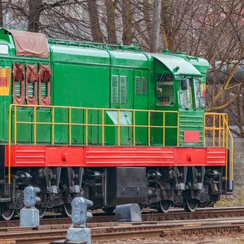 Green diesel cargo locomotive. Freight train in action