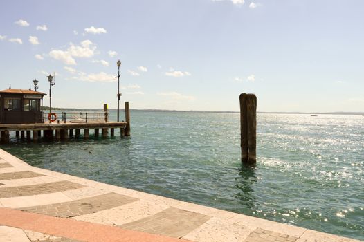 View of the guard lake and a wooden pontoon in Italy