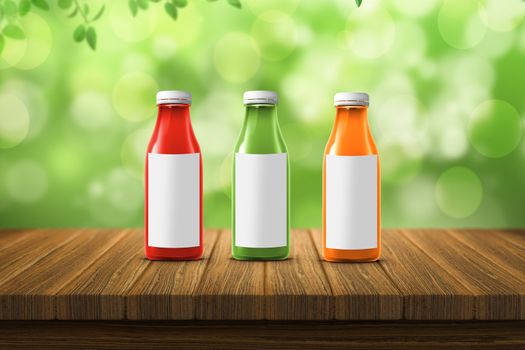 three multicolored bottles of juice are on the counter