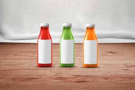 three multicolored bottles of juice are on the counter