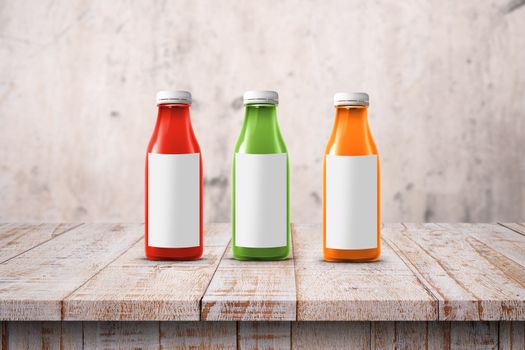 three multicolored bottles of juice are on the counter
