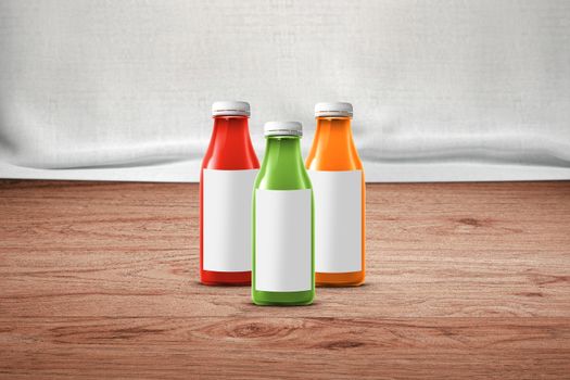 three multicolored bottles of juice are on the counter