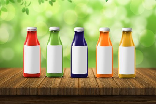 five multicolored bottles of juice are on the counter