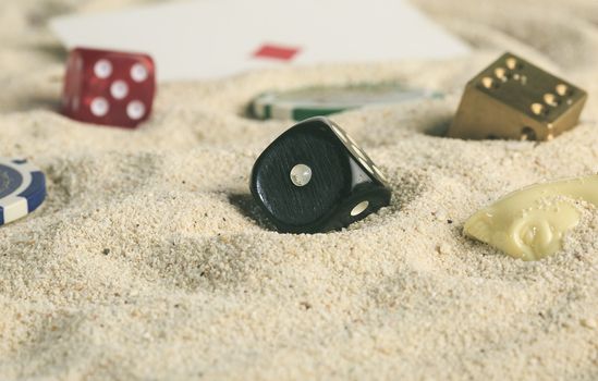 some dices buried in the sand dunes