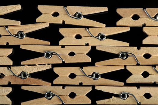 Group of wooden clothes pin in black background