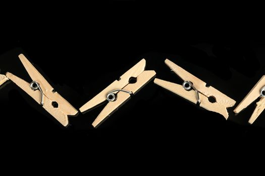 Group of wooden clothes pin in black background