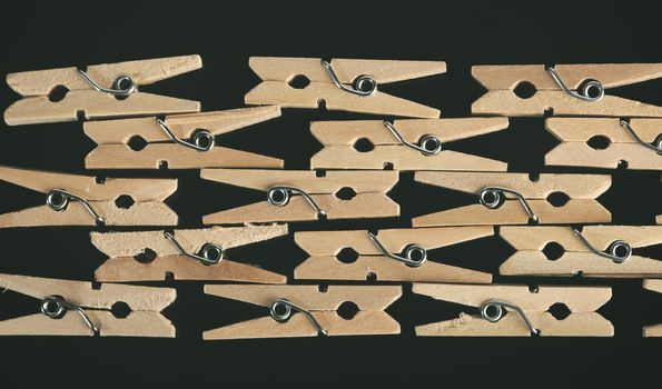 Group of wooden clothes pin in black background