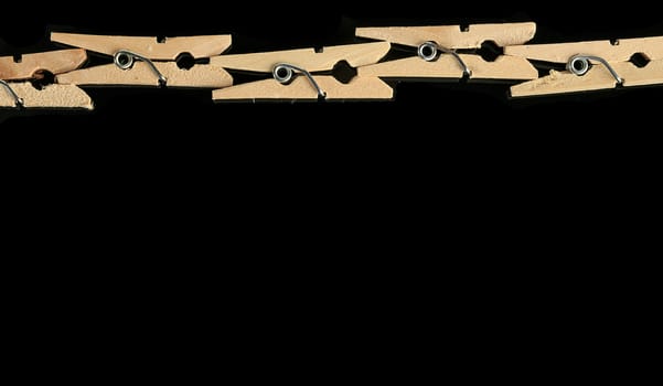 Group of wooden clothes pin in black background