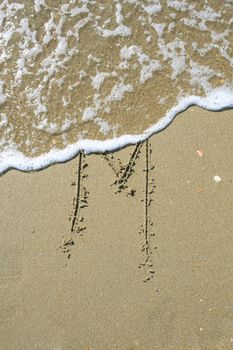 Letter drawn on the sand beach