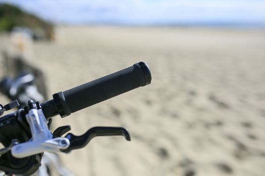 bicycle parked on the sand of the Beach