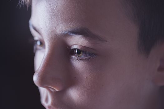 Boy with green eyes looking at the television