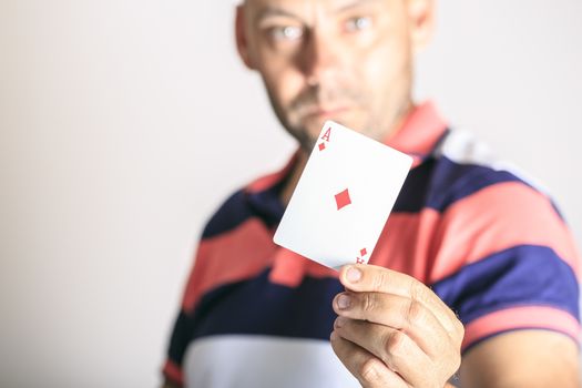 Man showing playing card in his hand