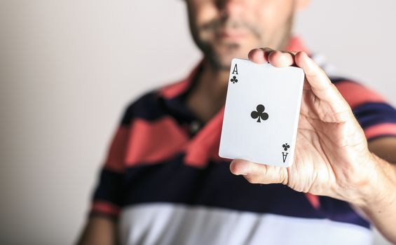 Man showing playing card in his hand