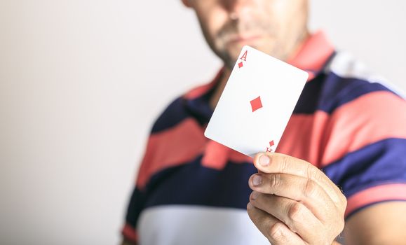 Man showing playing card in his hand