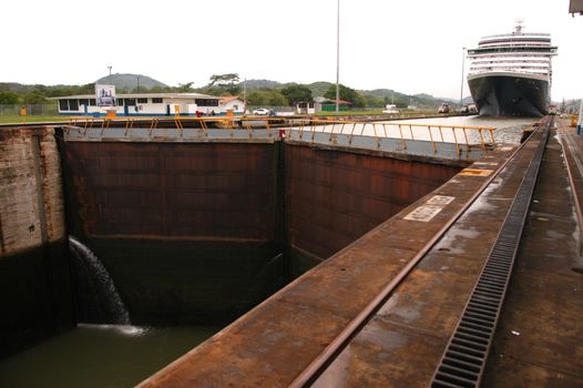 Cruise ship passing trough Panama canal on cloudy day